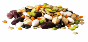 A pile of assorted dried beans, lentils, and dried peas in various colors on a white background.